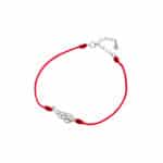 Srebrna bransoletka na czerwonym sznurku ze skrzydłem wysadzanym cyrkoniami.